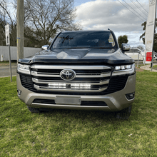 Load image into Gallery viewer, Toyota 300 Series Land Ultra Vision Cruiser Behind Grille Light Bar Kit
